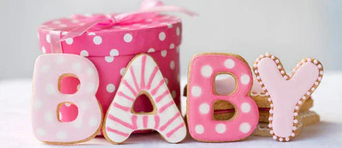 Delicious pink-themed cookies spelling 'BABY', perfect for a celebration, complementing the cozy baby nursery collection featuring blankets and swaddles.