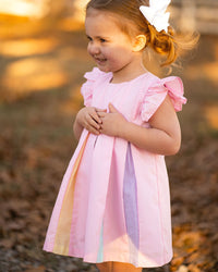 Pink swing dress for girls with flutter sleeves and colorful rainbow pleats. Perfect party dress for twirling.