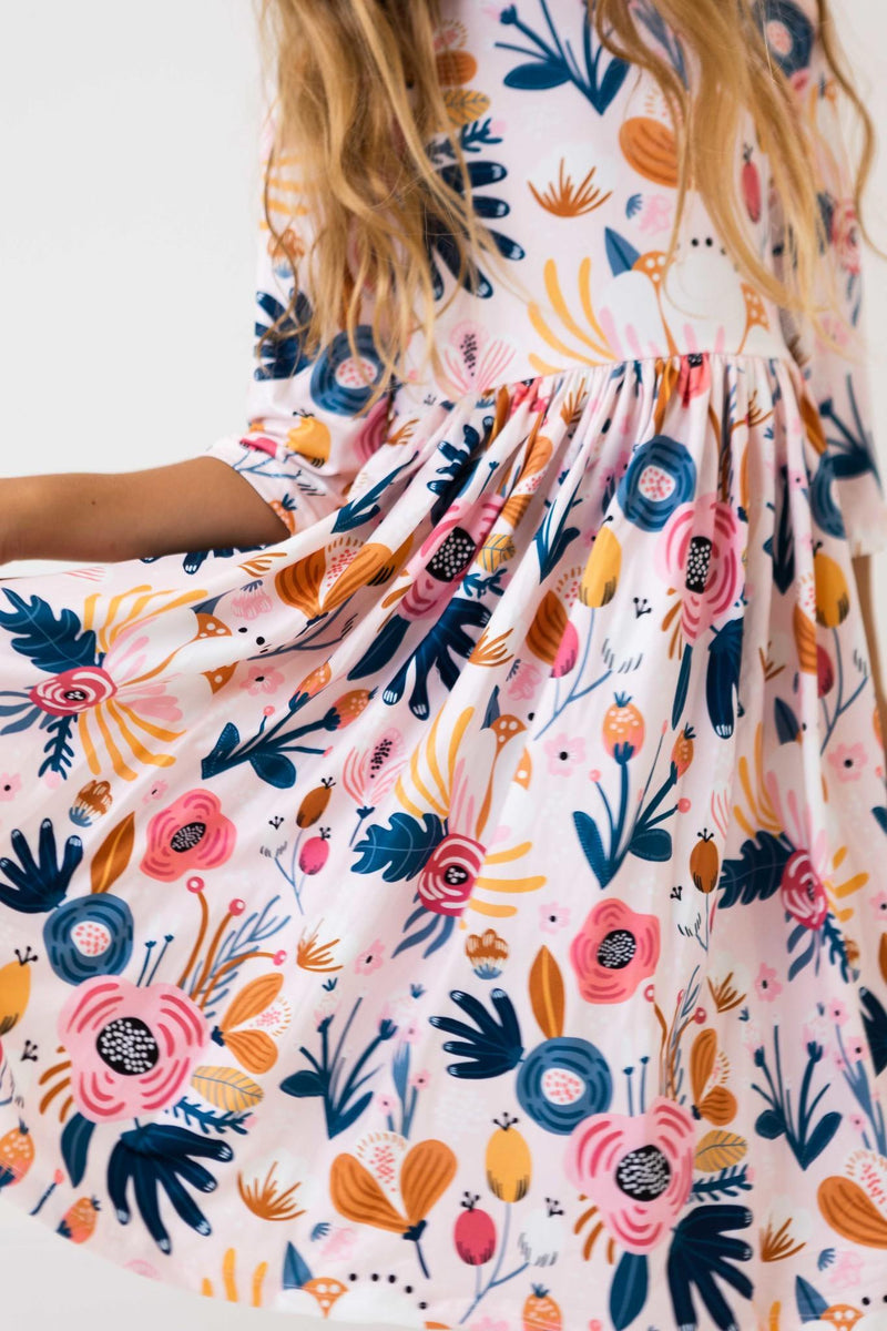 Full view of the Blush Peony 3/4 Sleeve Pocket Twirl Dress with pockets, perfect for storing little treasures during playtime.