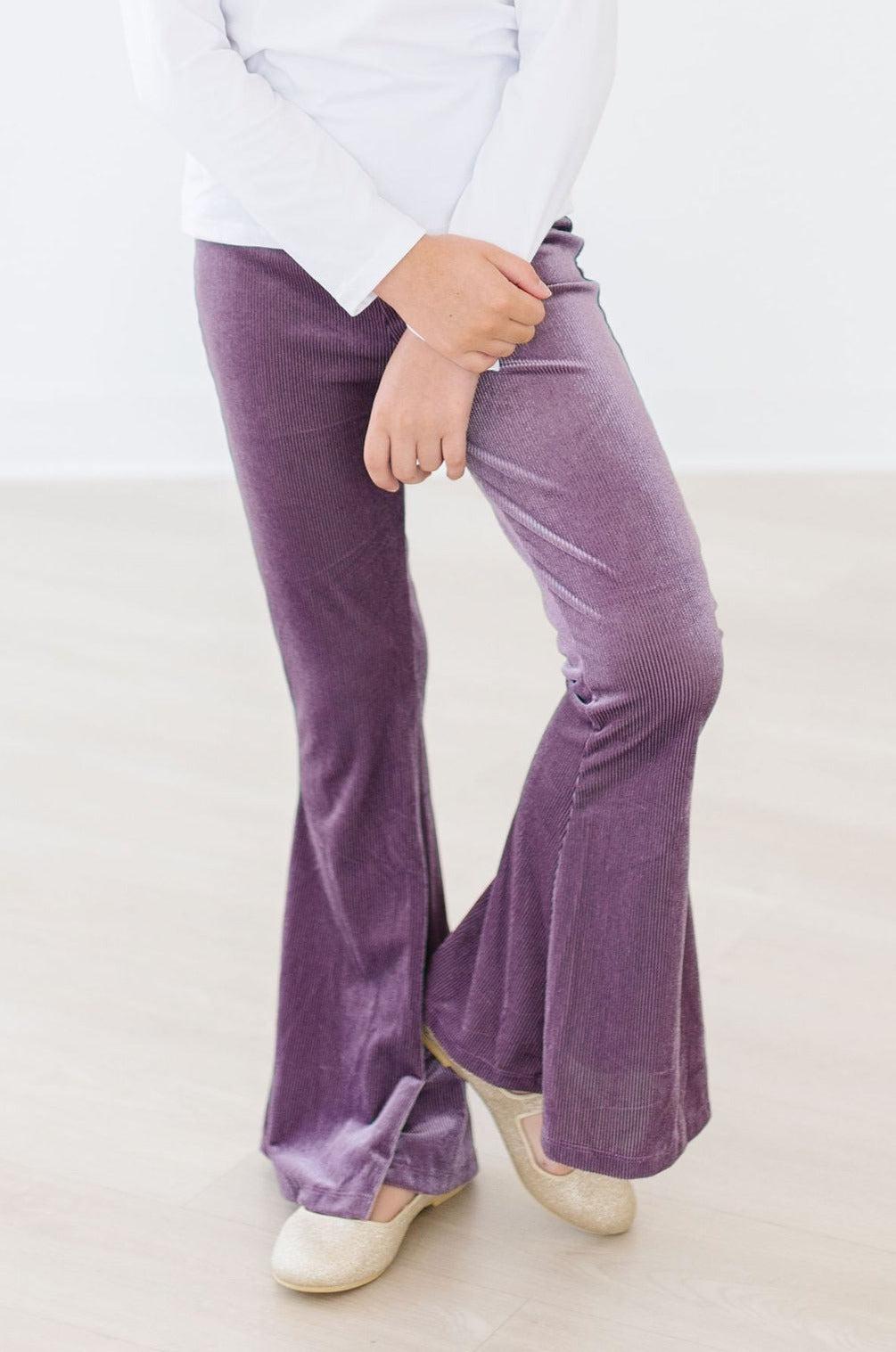 Stylish child in Amethyst Ribbed Velvet Bells, showcasing luxurious velvet fabric and trendy flared design, perfect for chic outings and family photos.