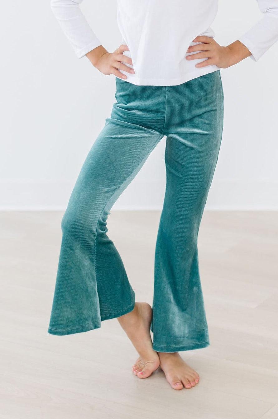 Child wearing Aquamarine Ribbed Velvet Bells, showing off a stylish high-waisted design with a flowing bell bottom. Perfect for comfort and fashion.