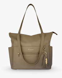 Taupe pebbled vegan leather diaper bag with gold zipper, side pockets, and feather tassel charm