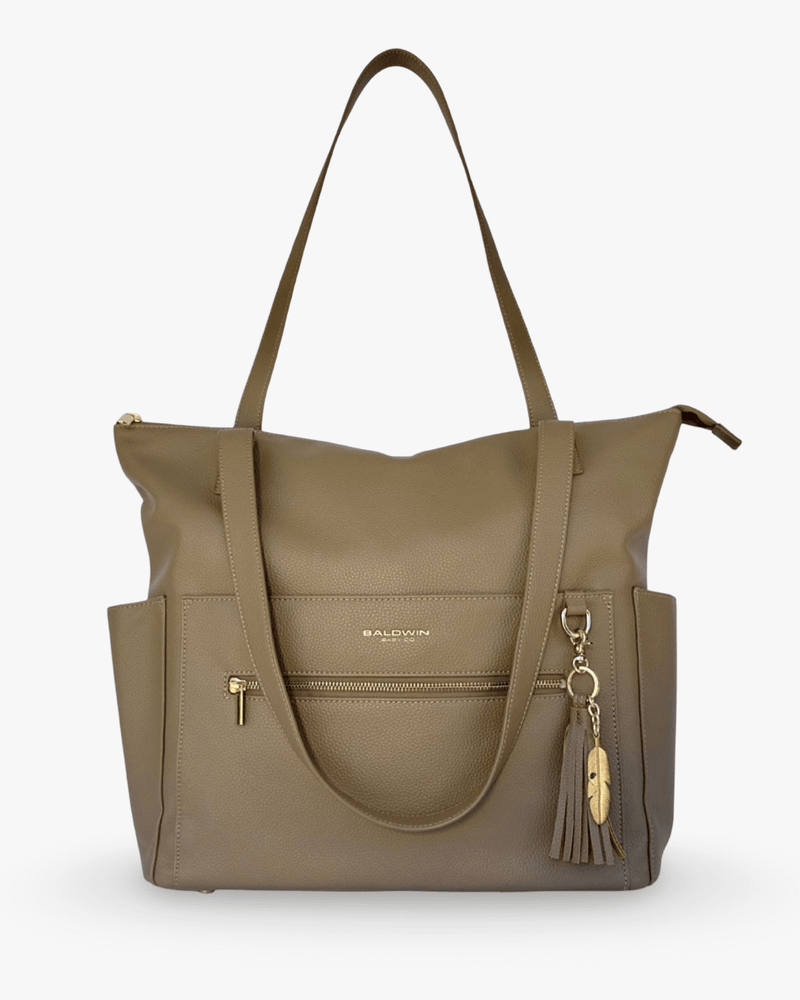 Taupe pebbled vegan leather diaper bag with gold zipper, side pockets, and feather tassel charm