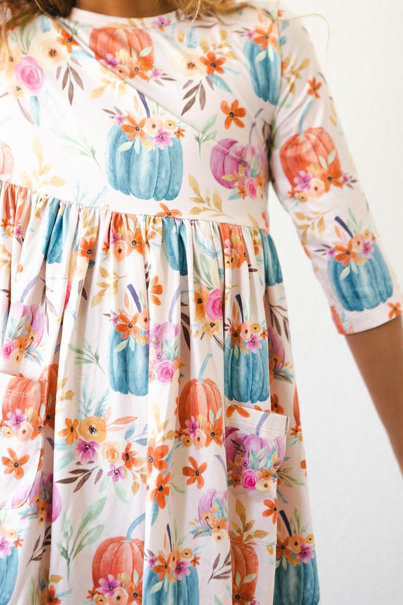 Harvest Blooms 3/4 Sleeve Pocket Twirl Dress featuring vibrant floral patterns with pumpkins, perfect for little girls who love twirling in style.