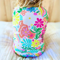 Back view of a child wearing Rainbow Daisy Babe two-piece pajamas with a bright floral pattern.