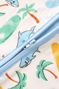 Close-up of a zipper on fabric with shark and palm tree patterns