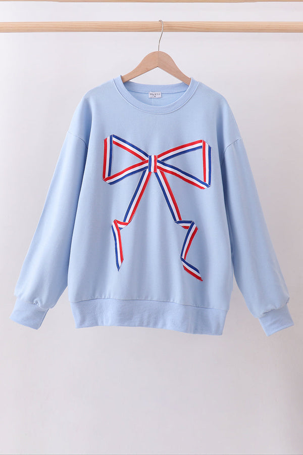 Light blue sweatshirt with a large red and blue bow design on a white background
