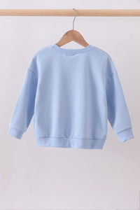 Light blue sweatshirt on a wooden hanger against a plain background