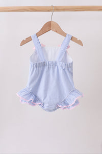 Blue and white striped baby romper with ruffles on a wooden hanger against a white background