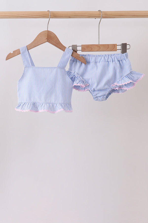 Blue-striped seersucker 2-piece swimsuit with pink frill trim on tank-style top and ruffled bottoms.