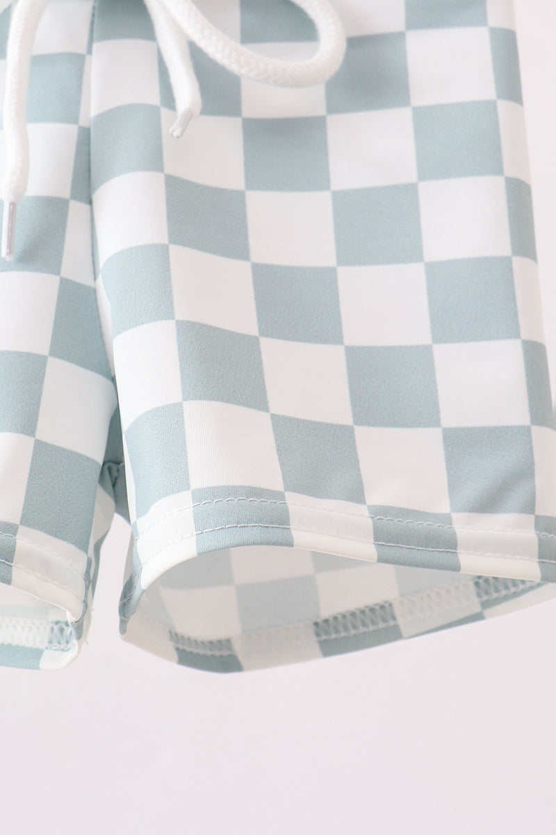 Checkered shirt with light blue and white pattern on a plain background