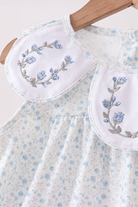 Floral embroidered dress with matching pouches on a white background