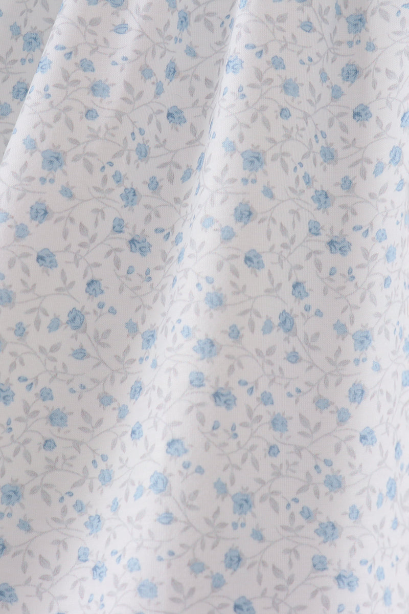 White fabric with small blue floral pattern