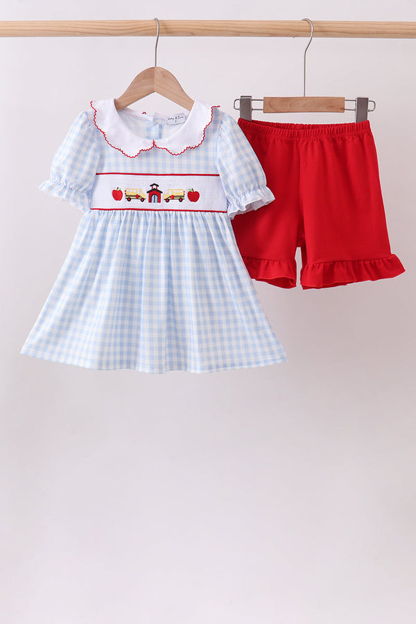 Blue school-bus print smocked top with gingham pattern and red ruffle shorts – kids two-piece set.