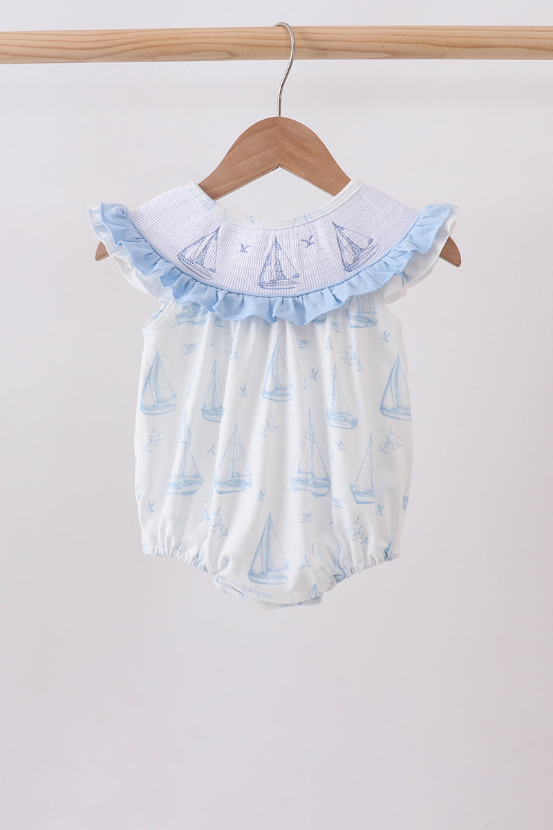 Blue Sailboat Smocked Ruffle Bubble with light blue sailboat print, smocked bodice, and ruffled collar.