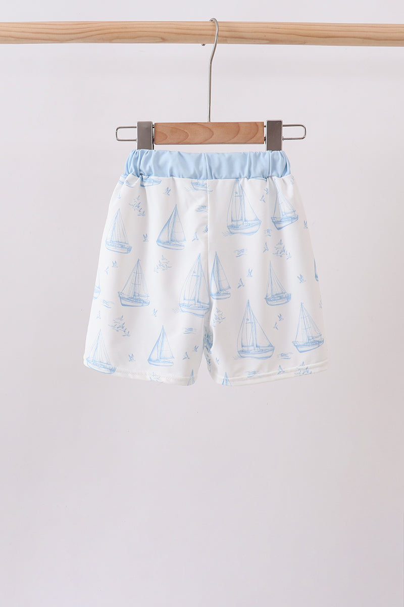Blue sailboat embroidered swim trunks with light blue waistband.