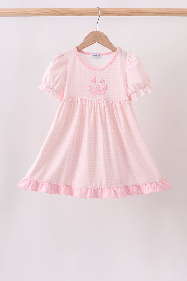 Pink Jack-O-Lantern Applique Dress in gingham with puff sleeves and ruffled hem.