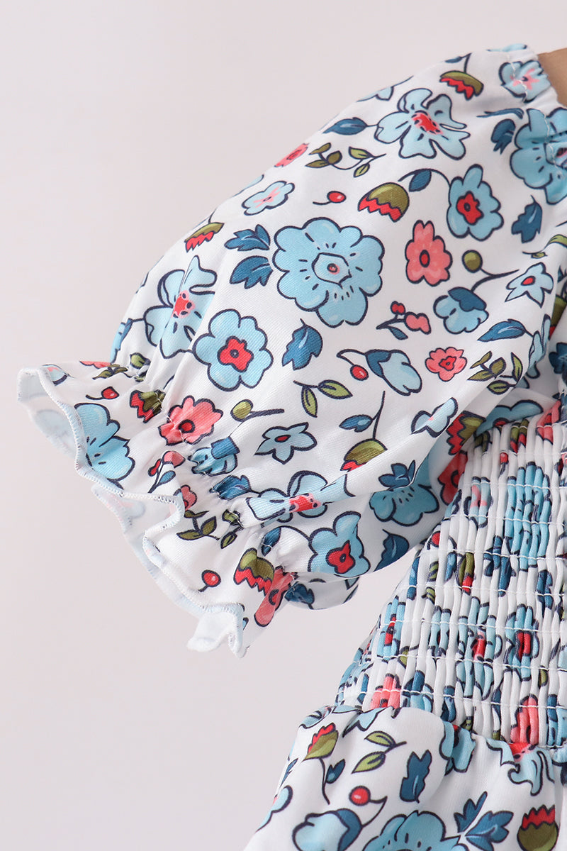 Blue floral girls dress with smocked bodice and ruffled puff sleeve detail.