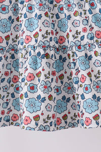 Blue floral girls dress featuring delicate smocked bodice detail and a soft, romantic ruffled hemline for elegant comfort.