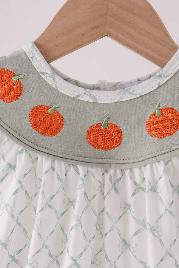 Sage green bubble outfit collar featuring orange pumpkin embroidery and white ruffled fabric with a subtle bow pattern.