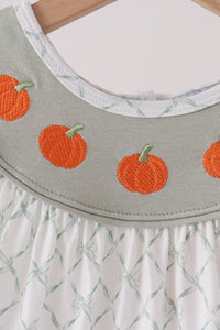 Sage green dress bodice featuring orange pumpkin embroidery and white bow pattern ruffle skirt.