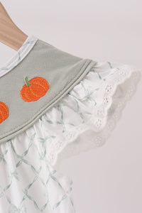 Sage green dress with orange pumpkin embroidery, ruffled lace trim, and ribbon pattern detail.