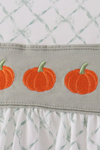 Sage ruffled bloomer waistband featuring orange pumpkin embroidery and white bow-patterned fabric for fall.