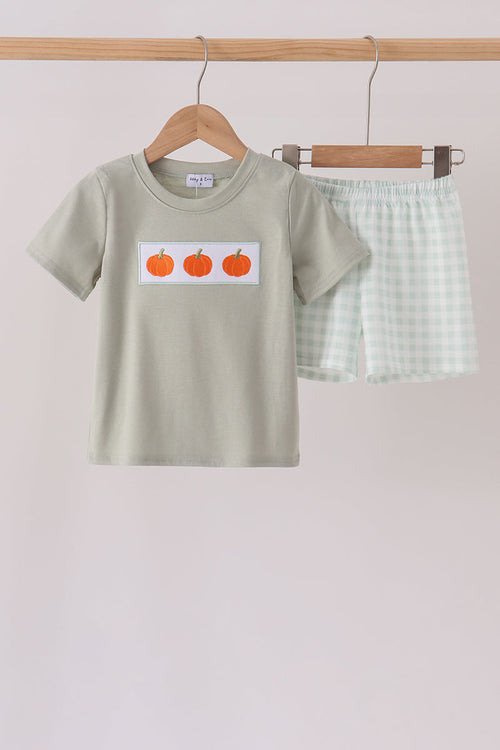 Sage green children's shorts set with gingham shorts and t-shirt featuring three orange pumpkin embroidery patches.