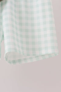 Sage green and white gingham短裤 hem detail, soft comfortable fabric with delicate stitching for fall wear.