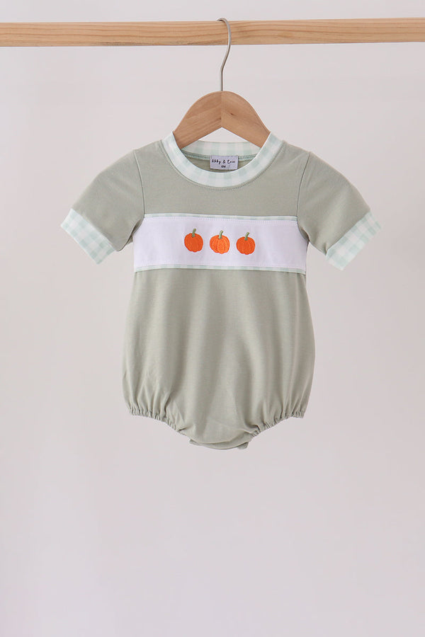 Sage green baby bubble with three orange pumpkin embryos on white band and gingham trim.