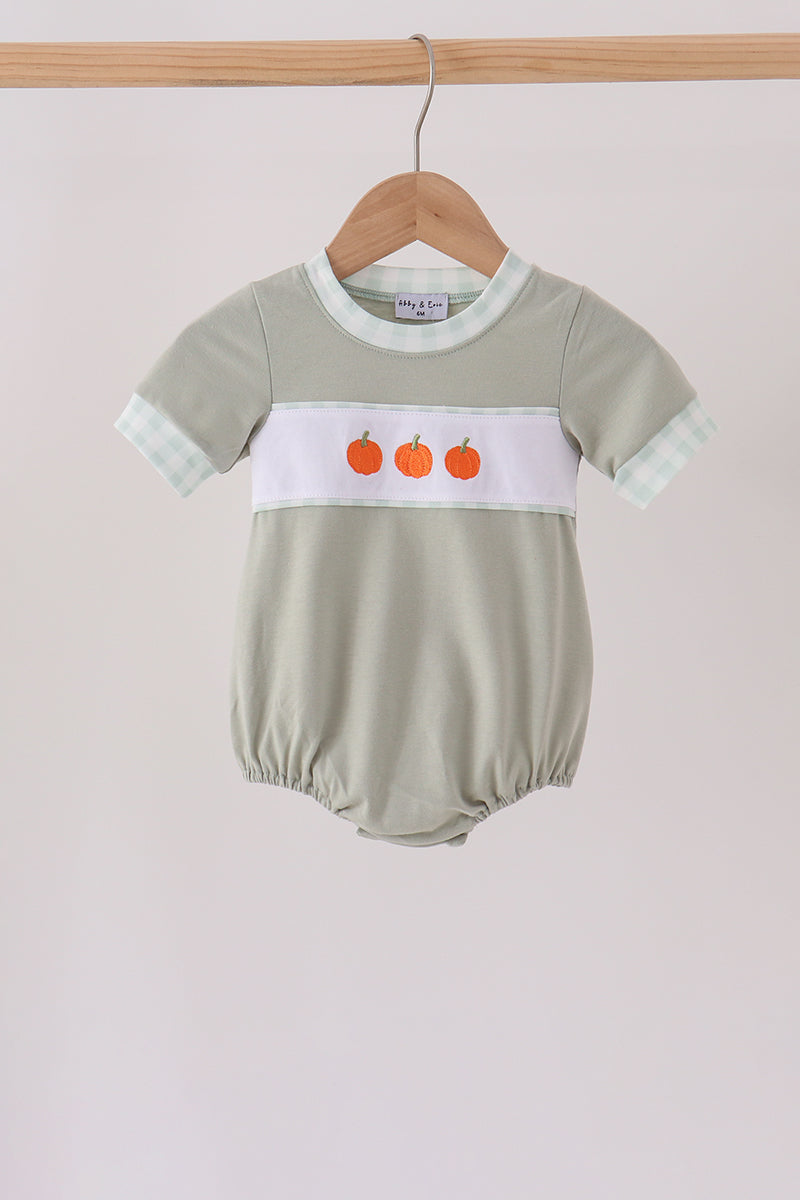 Sage green baby bubble with three orange pumpkin embryos on white band and gingham trim.
