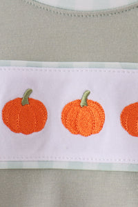 Sage green bubble with intricate orange pumpkin embroidery on white band, adding cozy autumn charm to fall wear.
