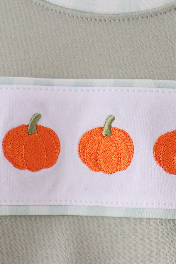 Sage green bubble with intricate orange pumpkin embroidery on white band, adding cozy autumn charm to fall wear.