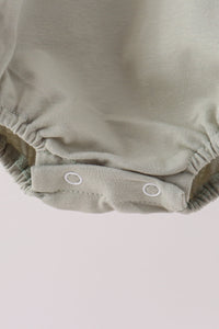 Sage green baby bubble onesie with elastic leg openings and white snap closure for easy dressing.