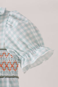 Sage and pumpkin gingham bubble with ruffled puff sleeve and orange embroidered smocking on bodice.