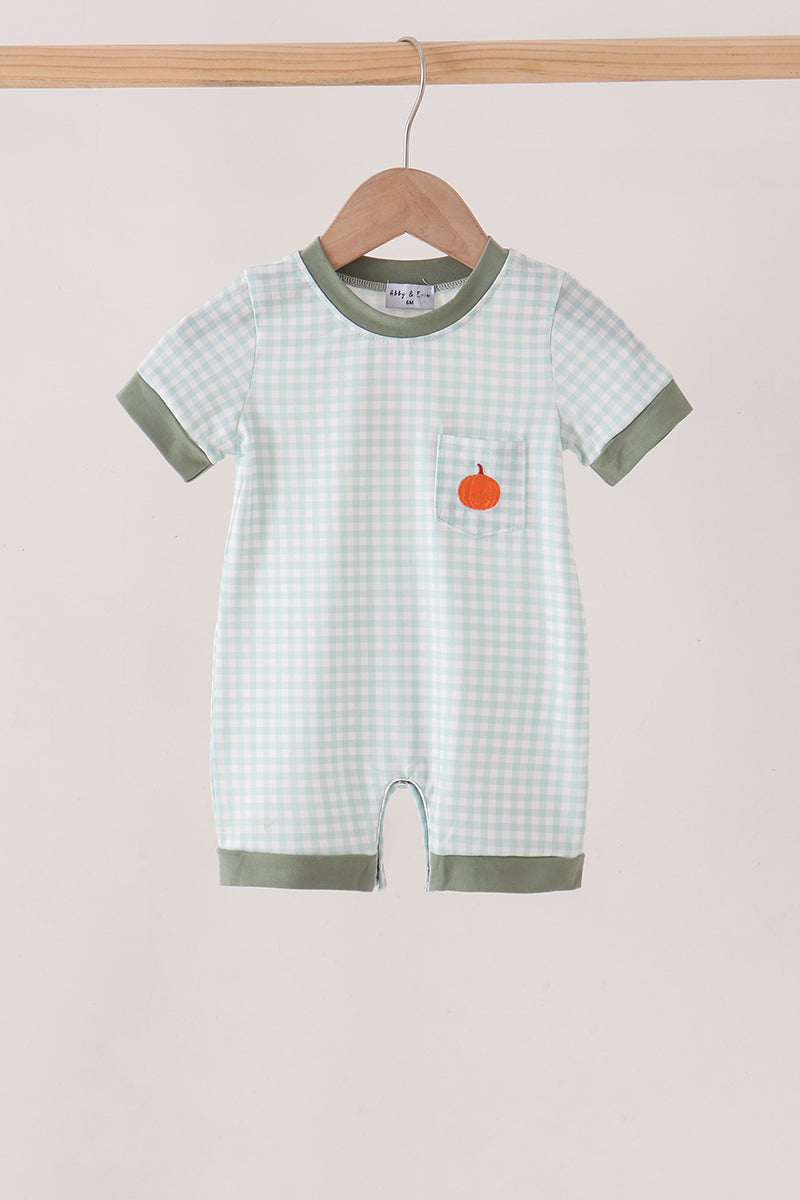 Sage green gingham romper with orange pumpkin embroidery on the chest pocket, featuring green trim and a hanger display.
