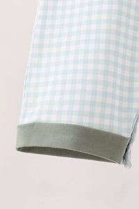 Light blue gingham romper hem with solid sage green cuff. Soft cotton fabric with fitted bodice and relaxed legs for fall comfort.