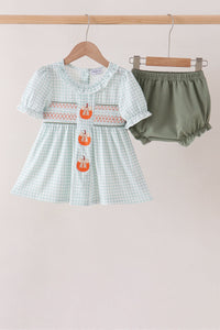 Sage gingham baby dress with embroidered pumpkin details and smocked chest, paired with solid olive green bloomer shorts.