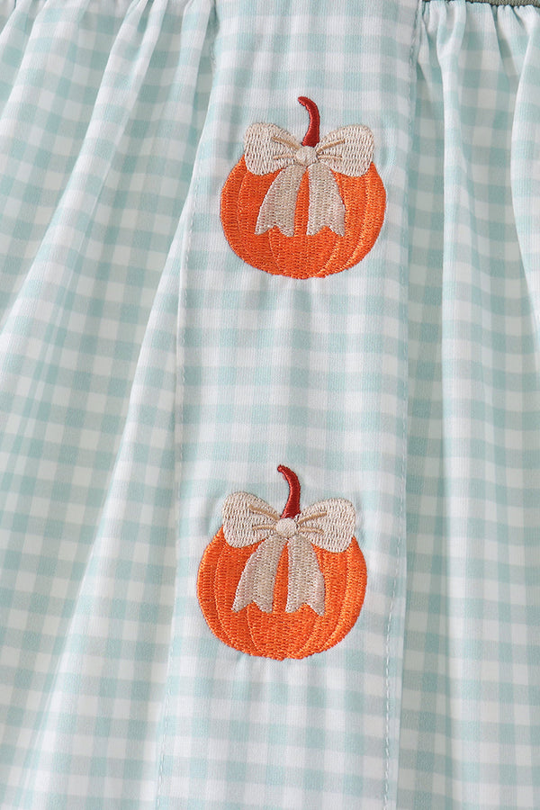 Sage green gingham dress featuring embroidered orange pumpkin patches with cream bows and delicate smocked detailing.
