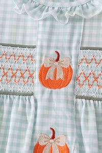 Sage and pumpkin gingham fabric with orange smocking and embroidered pumpkin patch with cream bow.