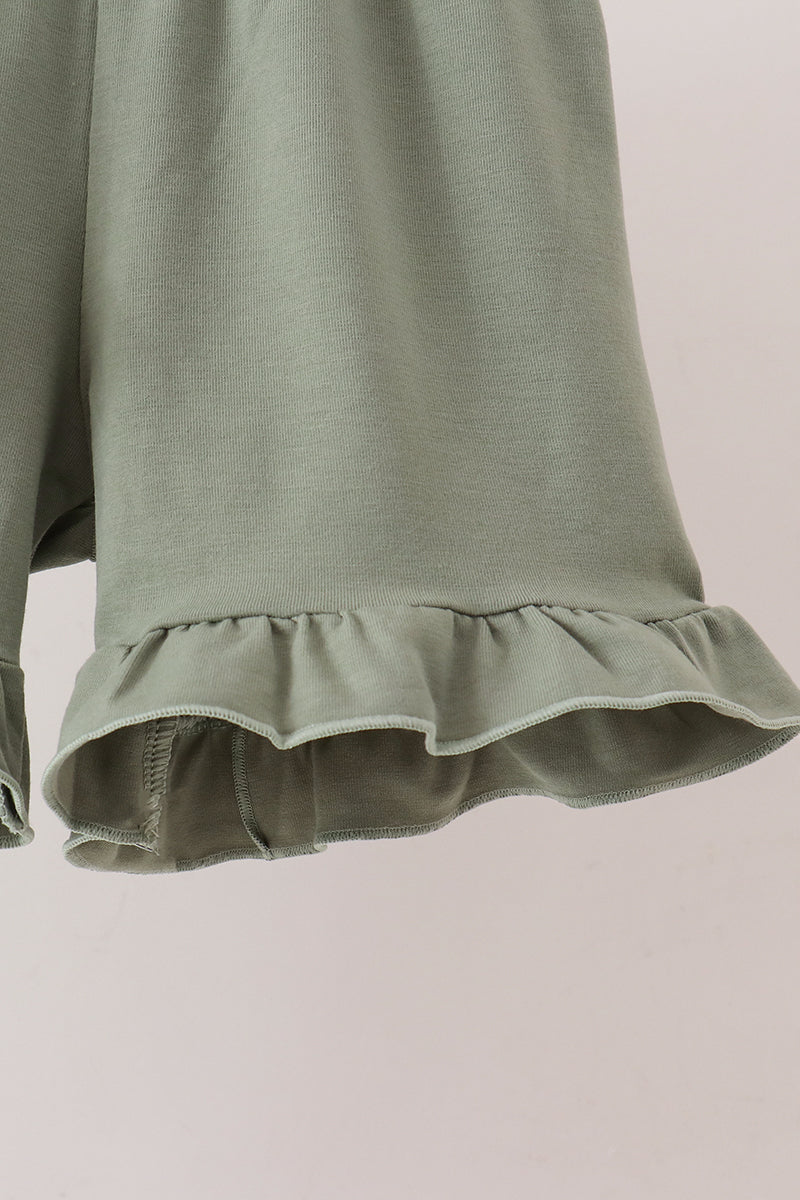 Sage ribbed knit shorts featuring a delicate ruffled hem detail for a comfortable and stylish children's outfit.