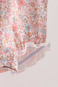 Pink floral bubble garment with ruffled hem, featuring delicate blue and pink flowers on soft fabric for autumn style.
