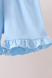 Light blue shorts featuring a soft, ruffled hem detail against a plain background.