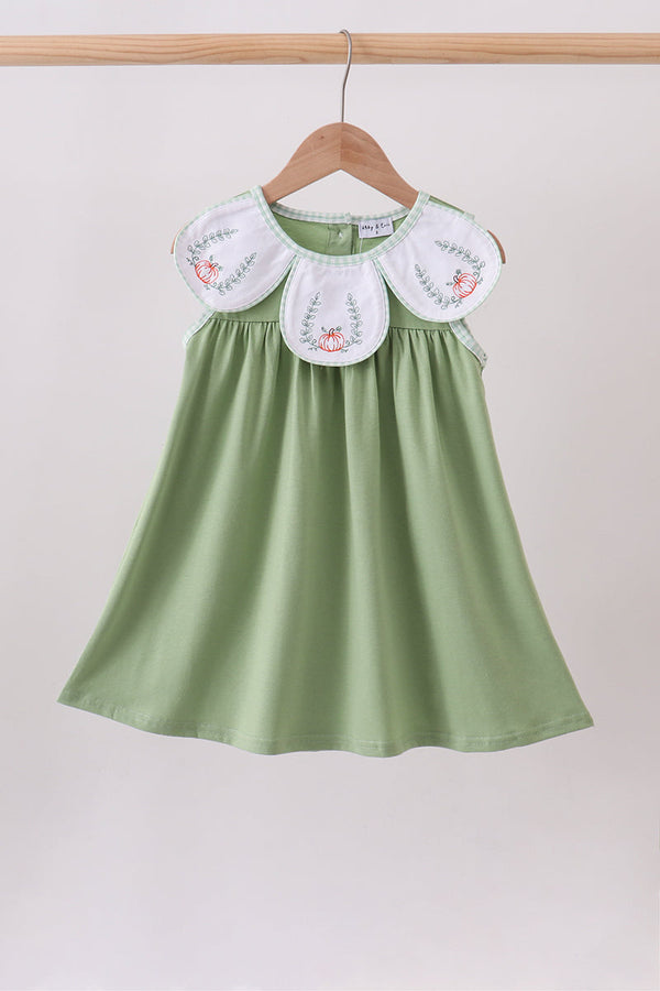 Sage green dress with white pumpkin-embroidered bib collar and relaxed fit.