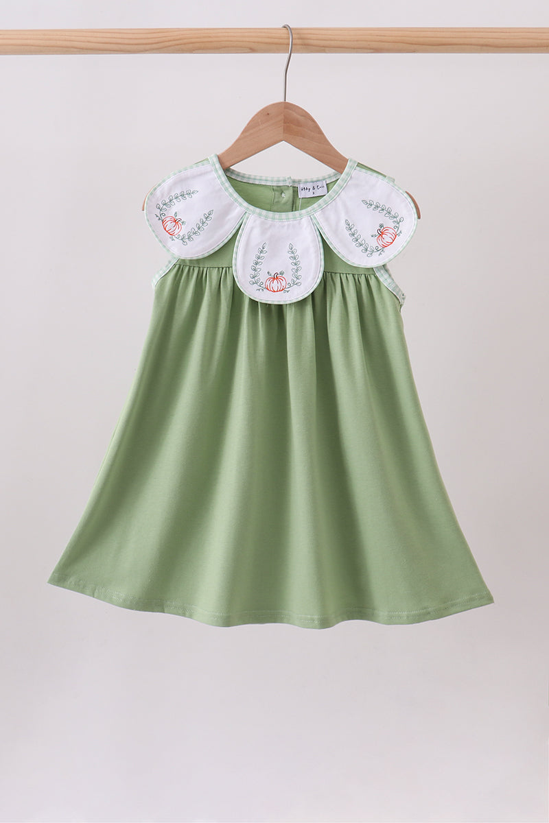 Sage green dress with white pumpkin-embroidered bib collar and relaxed fit.