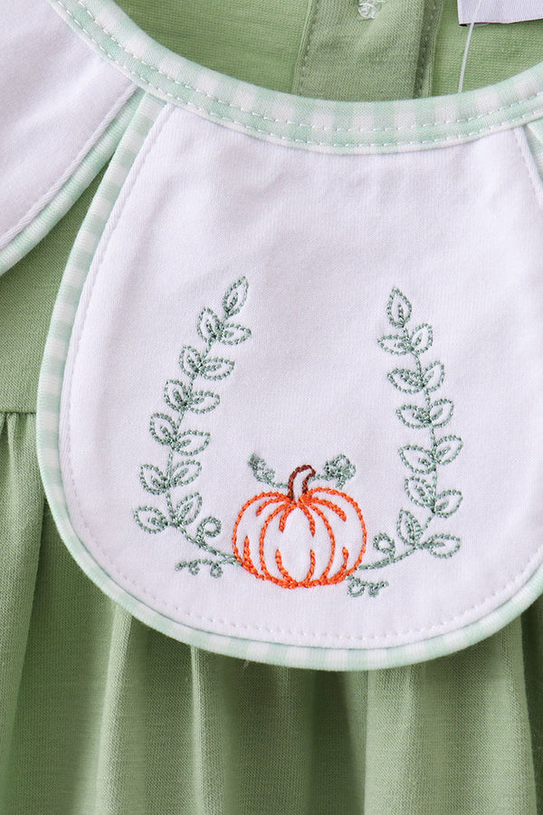 Sage Pumpkin Embroidered Dress: sage-green fabric with white bib and orange pumpkin embroidery.