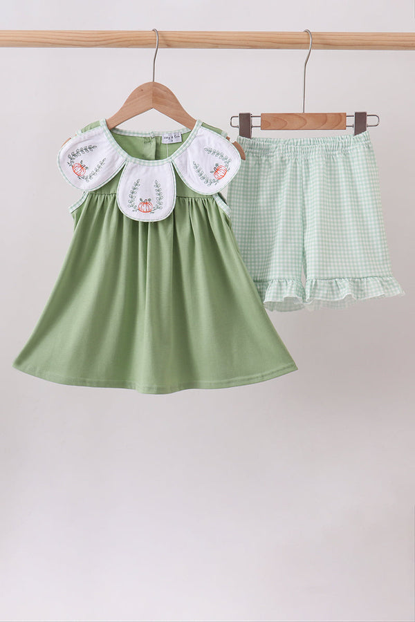 Sage green two-piece with pumpkin embroidery on white ruffle collars and gingham shorts with delicate ruffle hem.