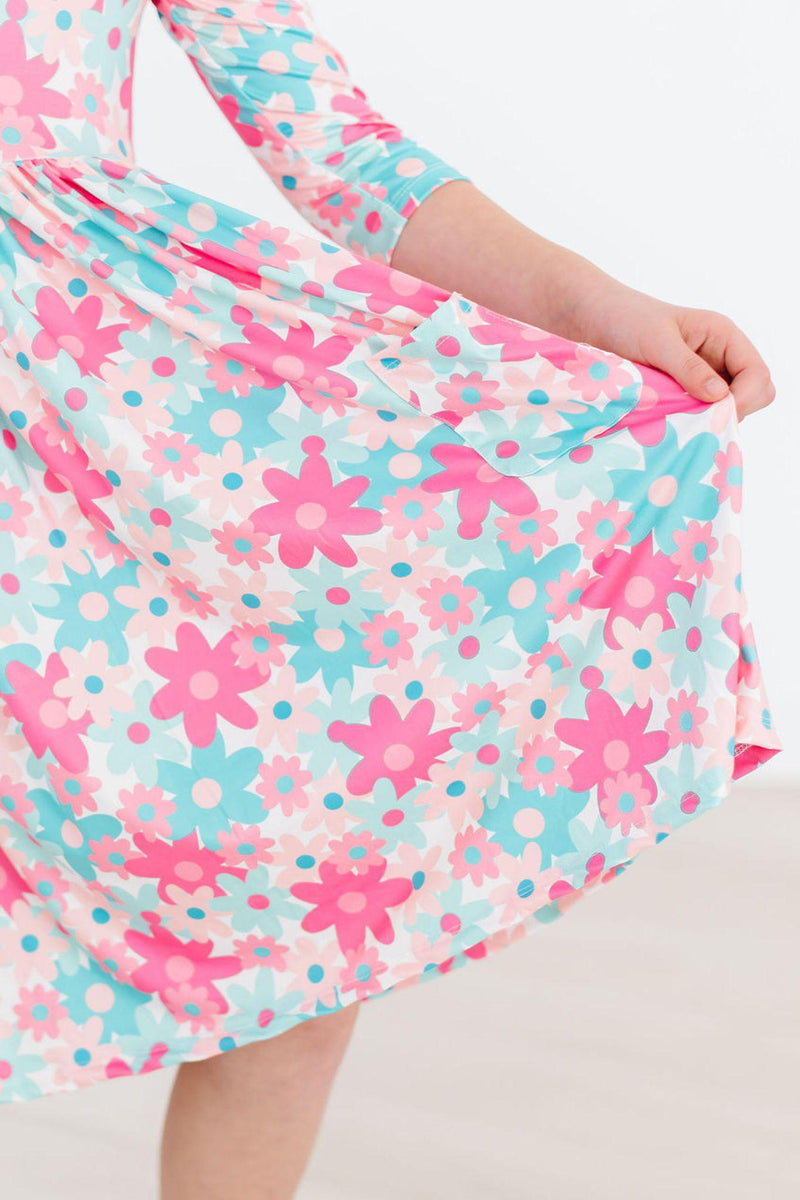 Close-up of the twirl-worthy skirt of the Petal Perfection 3/4 Sleeve Pocket Twirl Dress, highlighting the playful floral design and the fabric's delightful movement.