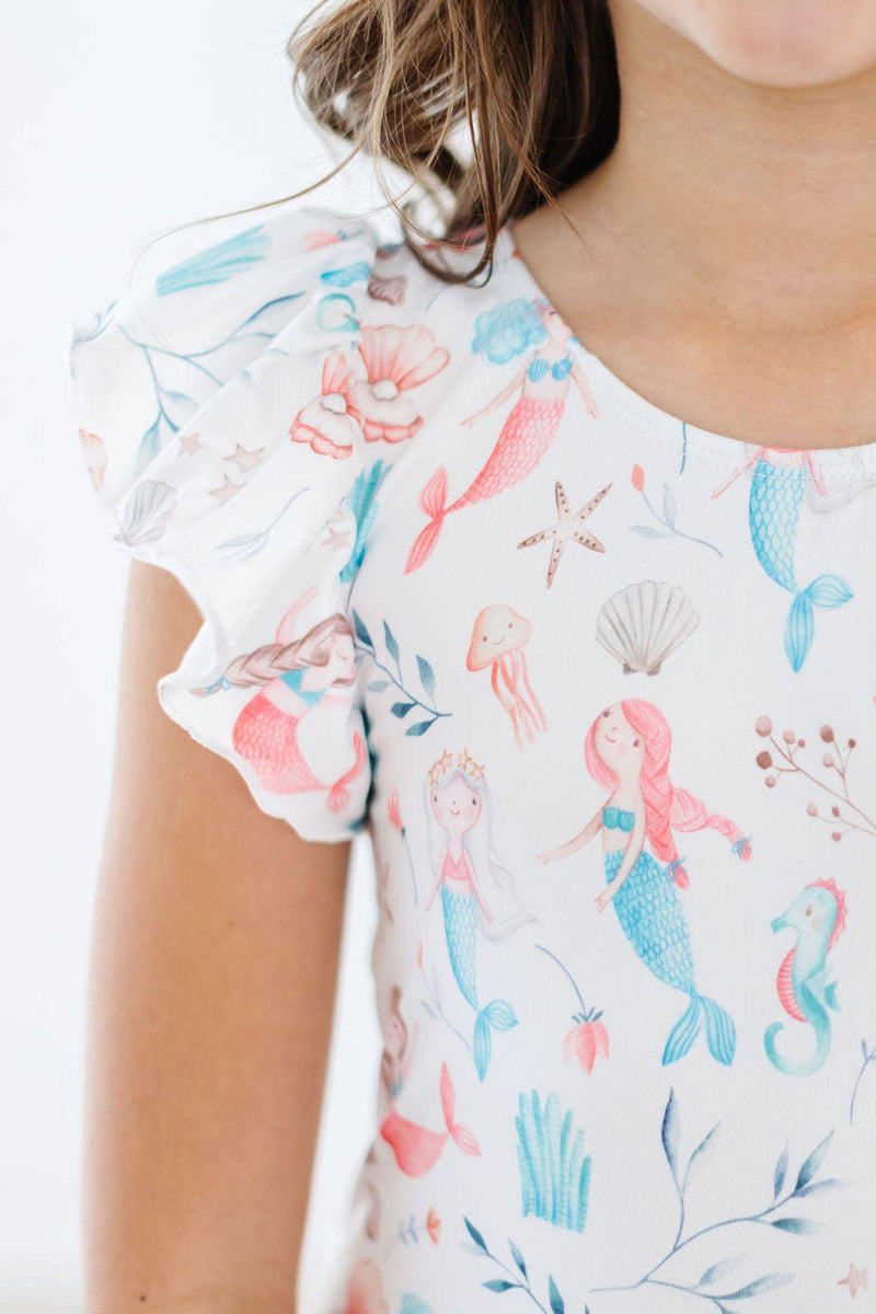 Close-up of the Mermaid Friends Short Sleeve Flutter Sleeve Leotard displaying the vibrant mermaid design, showcasing flutter sleeves and detailed artwork, ideal for young dancers in style.