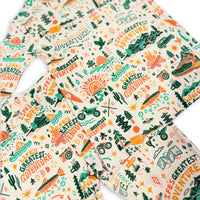 Close-up of The Second-Skin 2-Piece Long Sleeve Pajama print fabric with adventure motifs in teal, orange, and green.